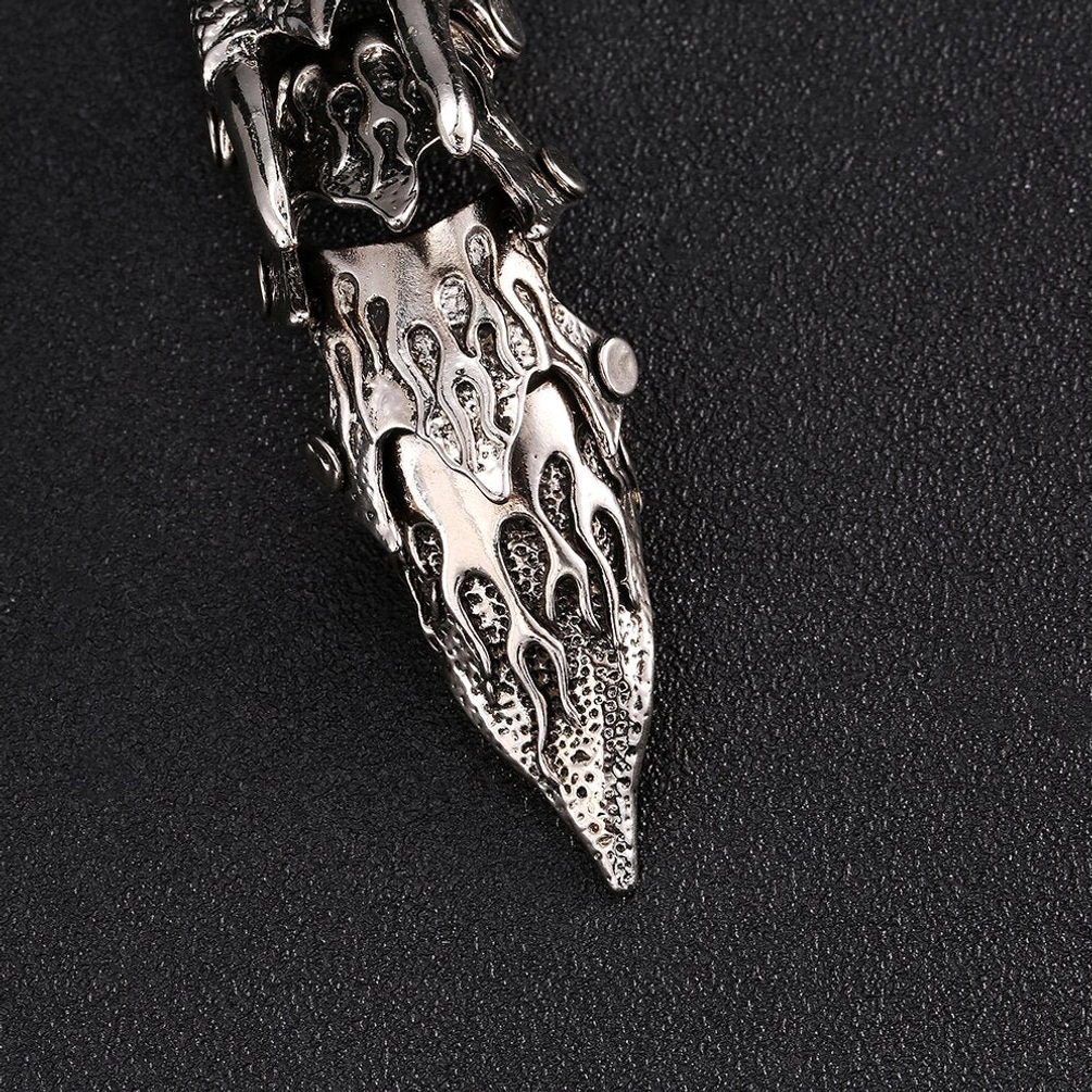 Detailed tip and claw section of steampunk owl finger armor emphasizing the hand-engraved flame textures, vintage antique silver-plated metal finish, segmented articulated design, and mechanical precision metalwork