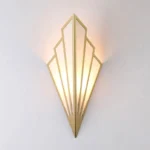 Art Deco Steampunk wall lamp with golden brass frame and linen shade, skyscraper geometric silhouette, front view