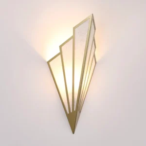 Illuminated Art Deco Steampunk wall sconce with warm glow, three-quarter angle view showing stepped angular design