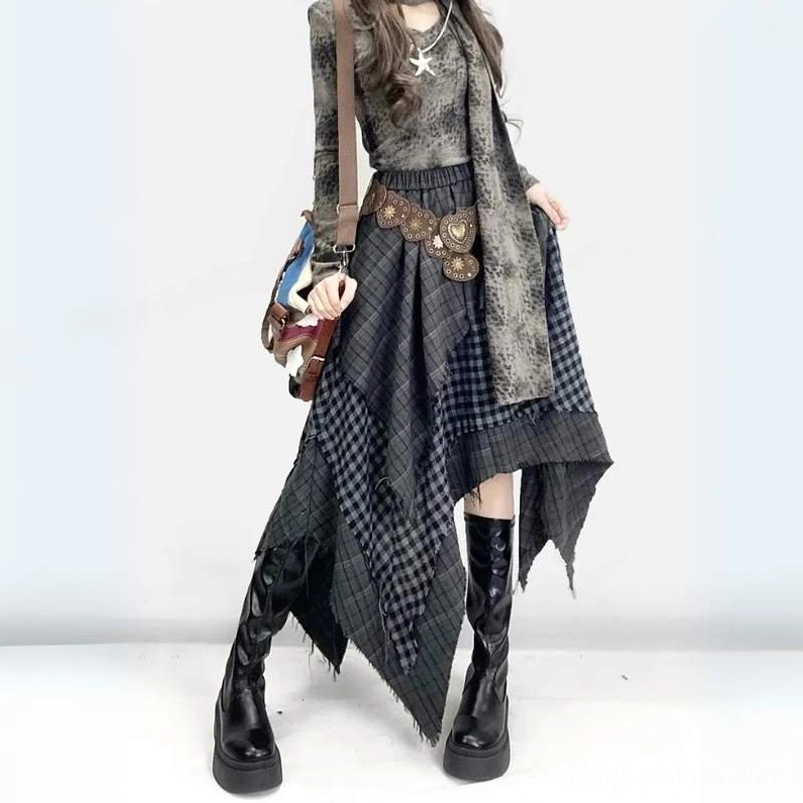 Asymmetrical plaid steampunk gypsy skirt with handkerchief hem worn with faded tie-dye top and brown waist chain, front three-quarter view