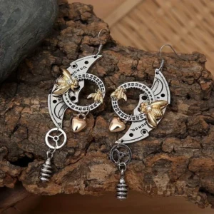 Vintage bee steampunk earrings with gemstone embellishments and precision-cut gear pendant displayed on rustic wood and stone backdrop