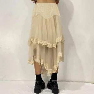 Beige steampunk midi skirt rear three-quarter view showing tiered ruffle construction and asymmetric hem