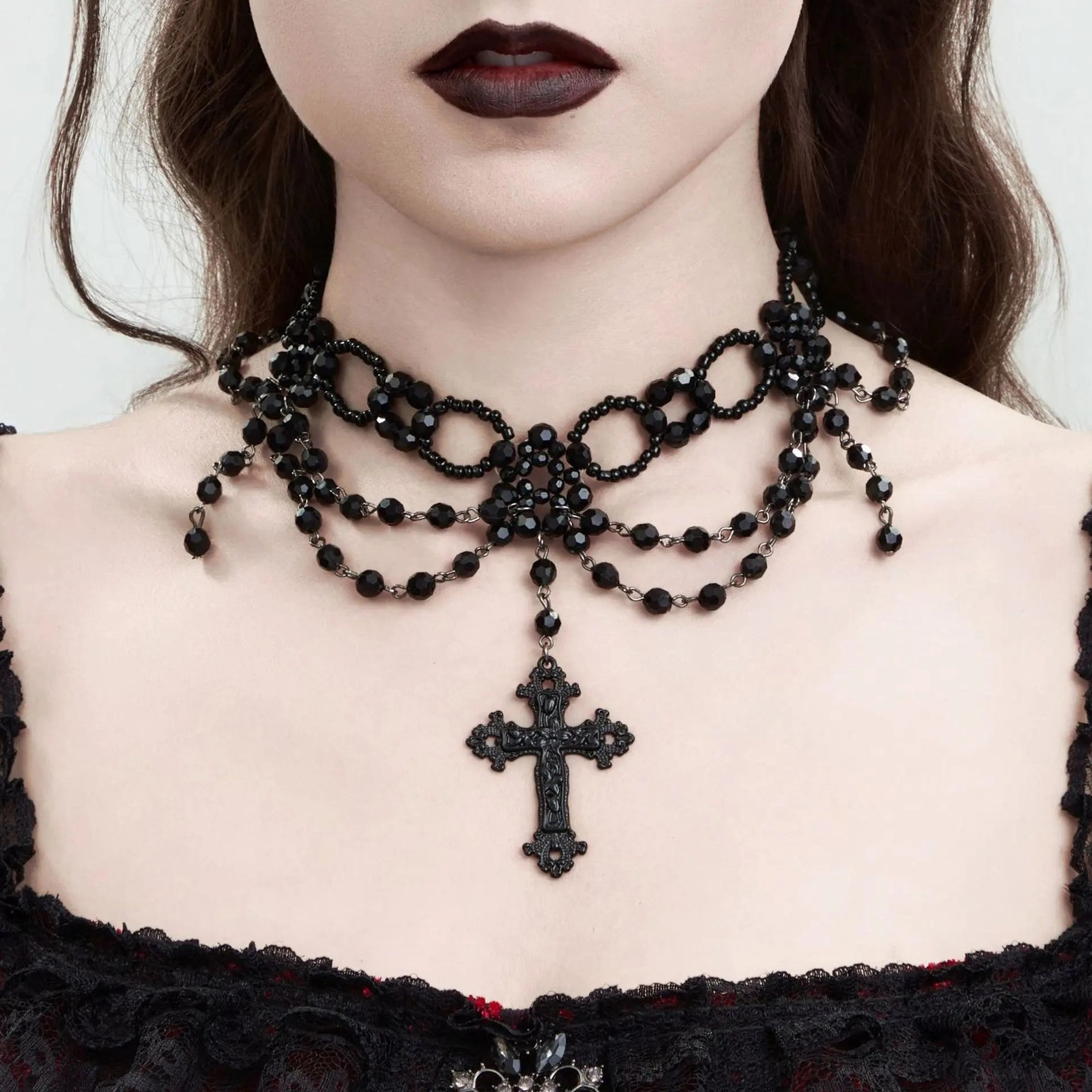Gothic cross choker necklace close-up on model neck showing dark beaded design with engraved pendant and Victorian aesthetic styling
