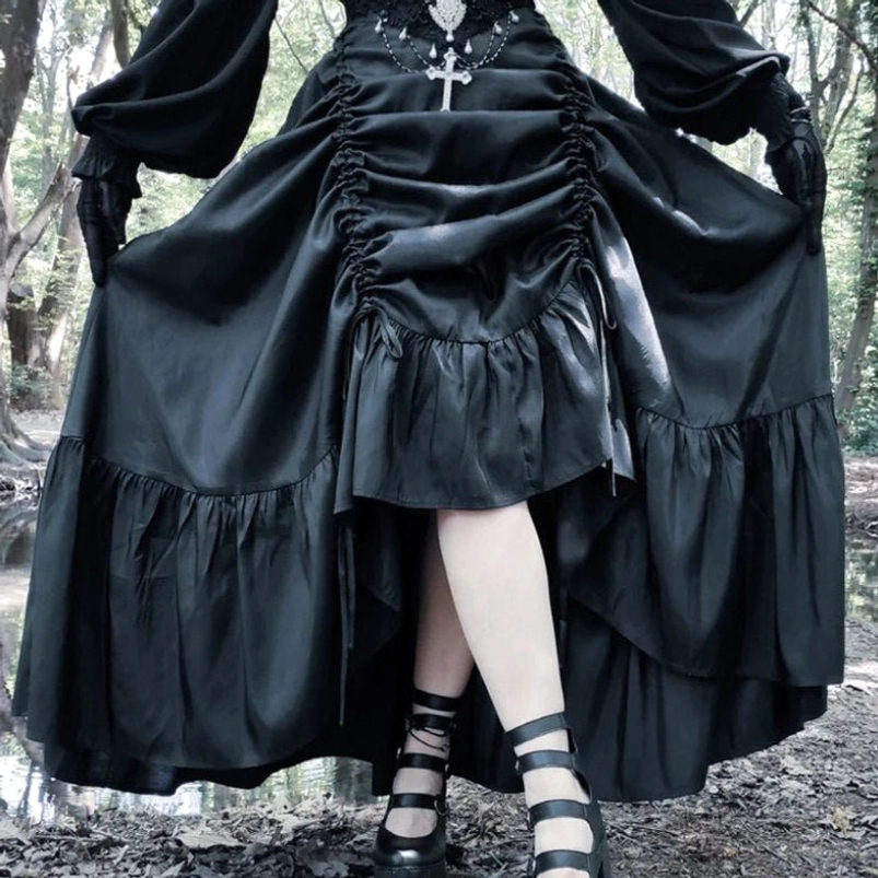 Black gothic steampunk high-low skirt with front drawstring ruching in outdoor woodland setting