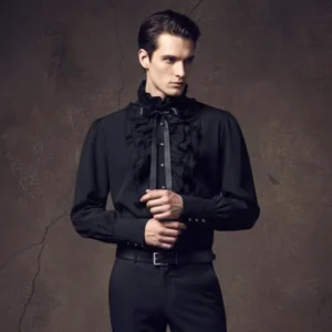 Black gothic vampire shirt with ruffled jabot and satin bow tie, modeled on male fashion model in dark studio setting showcasing steampunk style
