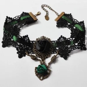 Black lace gothic steampunk choker necklace with green satin rose pendant and bronze filigree hardware, flat lay overhead view