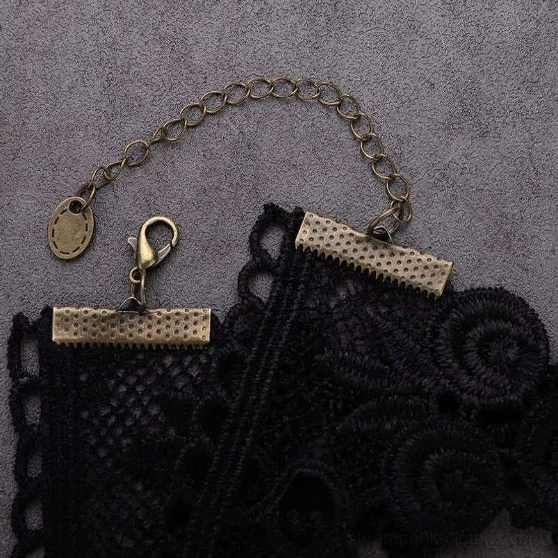Close-up flat lay of steampunk choker components including black crochet lace band, bronze metal fasteners, and extended chain mechanism for sizing flexibility