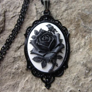 Black rose cameo steampunk necklace pendant with ornate vintage metal frame and black bead chain, close-up detail view
