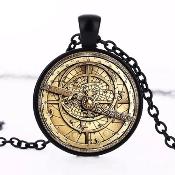 Black steampunk astrolabe necklace with bronze astrolabe pattern and black metal chain, flat lay on white background showing front detail and design clarity
