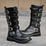 Black steampunk biker boots with multiple silver metal buckle straps and lace-up front closure, displayed on outdoor concrete pavement