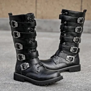 Black steampunk biker boots with multiple silver metal buckle straps and lace-up front closure, displayed on outdoor concrete pavement