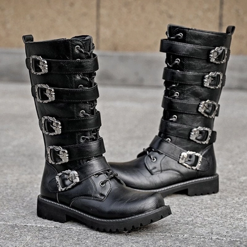 Black steampunk biker boots with multiple silver metal buckle straps and lace-up front closure, displayed on outdoor concrete pavement