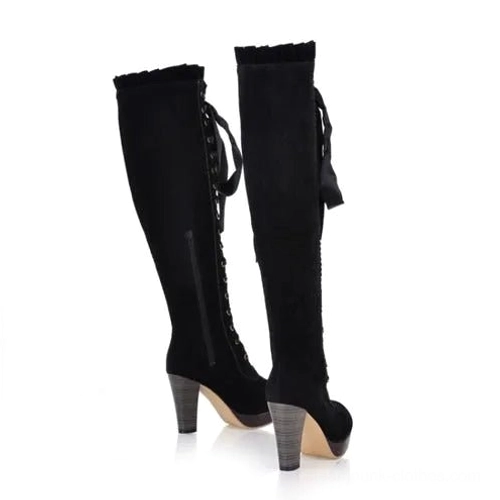 Black steampunk over-the-knee boots with side zipper closure, satin ribbon laces, and ruffled boot cuff, rear side view on white background