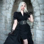 Black steampunk corset waist belt with silver engraved triple buckles and gold studs, worn by model in outdoor stone archway Victorian setting