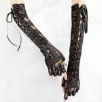 Black steampunk fingerless long lace gloves flat lay showcasing satin ribbon lacing and floral lace texture detail on mannequin hands