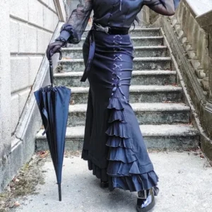Black steampunk fishtail skirt back view showing dramatic ruffled hem and lace-up side construction with model holding vintage umbrella