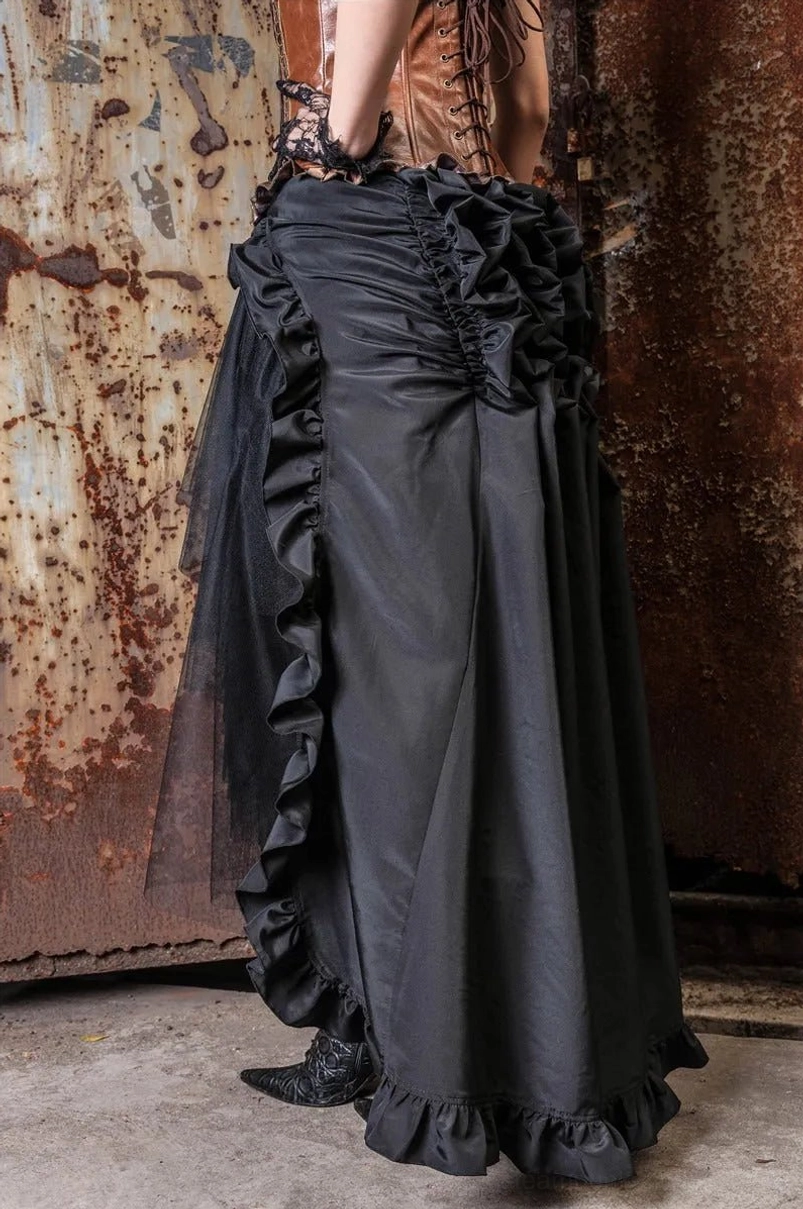 Black steampunk overlay skirt partial side view showing asymmetric high-low cut and ruffle trim details