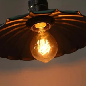 Black steampunk industrial pendant lamp with fluted metal shade and warm Edison bulb, low-angle bottom view showcasing ribbed design and bronze lamp socket