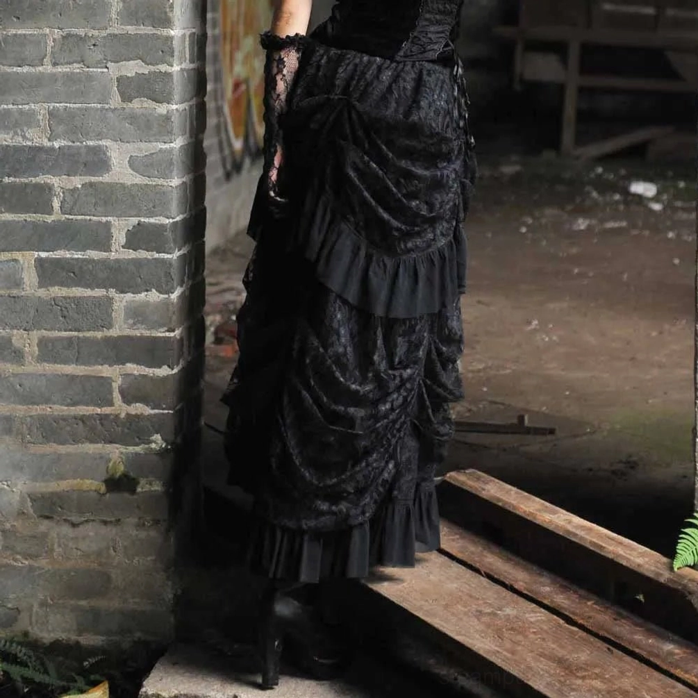Steampunk layered skirt right side view on model, showing ruched fabric construction and ruffled trim detail in industrial setting