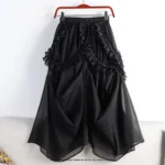 Black gothic steampunk skirt with mesh overlay and studded ruffles displayed on hanger, full front view showing voluminous silhouette and layered construction