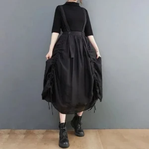 Black steampunk suspender midi skirt rear view showing adjustable straps and drawstring ruching details