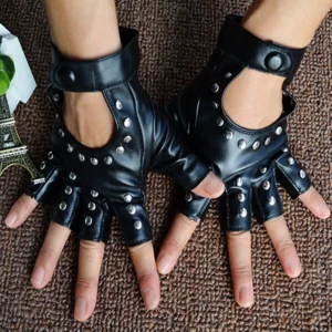 Pair of black fingerless steampunk gloves worn on hands, flat lay overhead view, silver rivets visible, brown carpet background