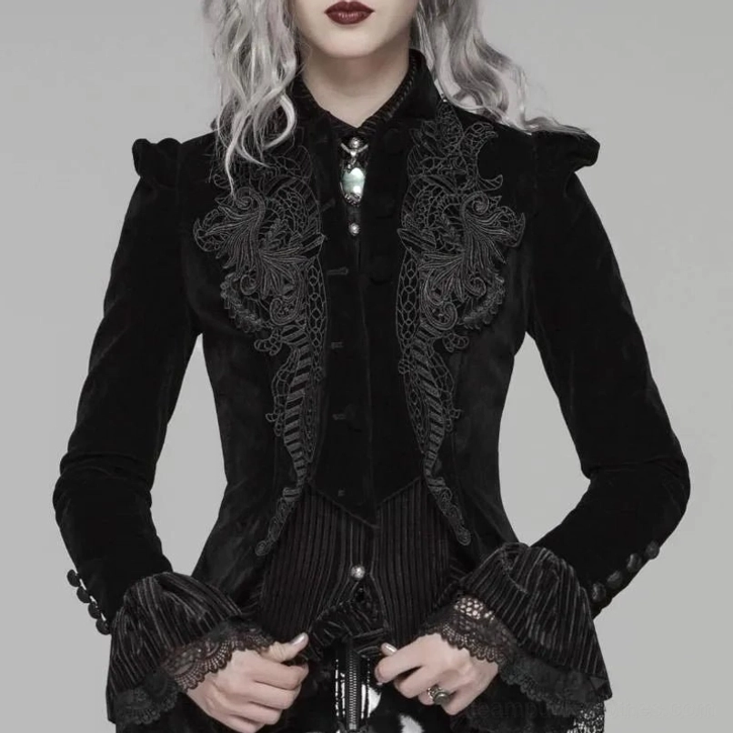 Black velvet gothic steampunk jacket with ornate grey embroidery on front bodice, lace-trimmed cuffs, detailed close-up showing hand-placed embellishment patterns and rich fabric texture