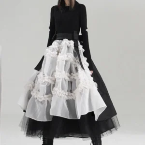 Steampunk skirt back view with high-low asymmetrical hemline, paired with black long-sleeve top and wide black waist belt, showcasing ruched organza details from rear three-quarter angle