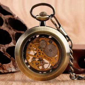 Antique bronze skeleton pocket watch close-up showing detailed internal gear movement and attached vintage pocket chain on wooden surface
