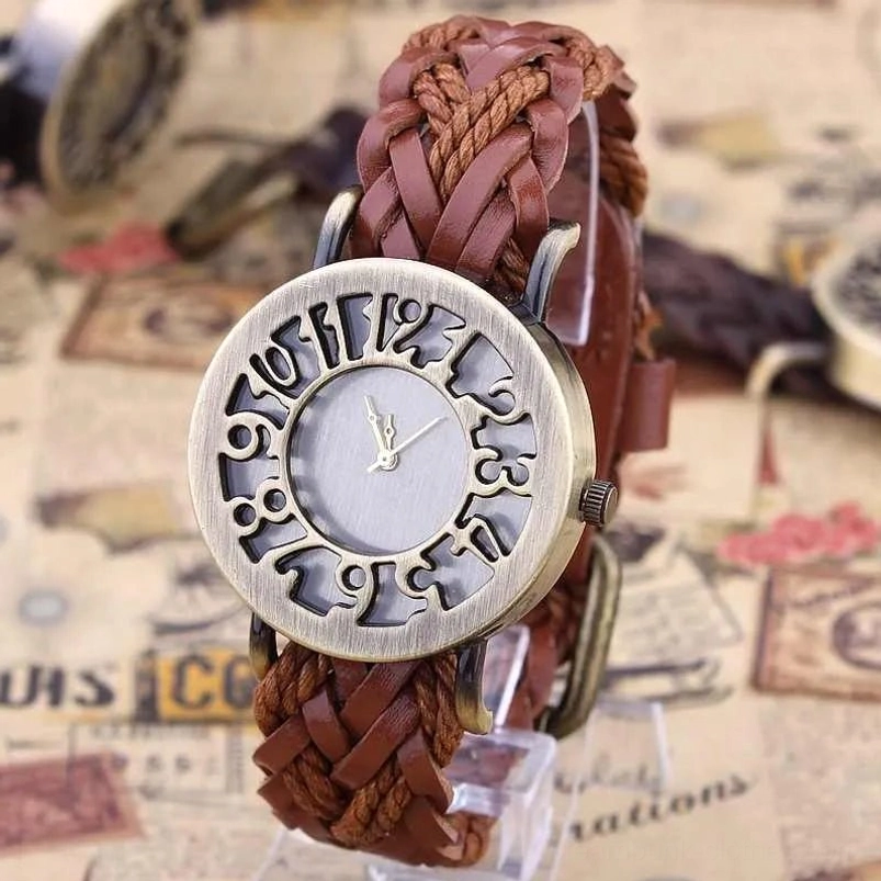 Bronze steampunk watch with brown braided leather strap, overhead view showing hollow vintage numerals and ornate dial face on newspaper backdrop