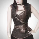 Brown brocade steampunk corset outfit with bolero and leather belt on goth model, front three-quarter view showing bronze metal eyelets and leather accents