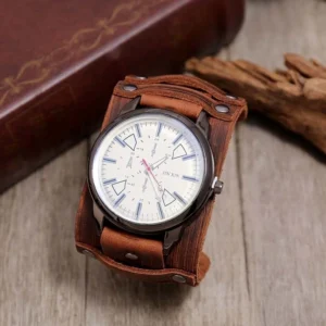 Brown distressed leather steampunk watch with white geometric dial, vintage book and driftwood styling, flat lay photography