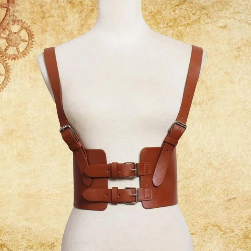 Brown steampunk leather harness belt with dual adjustable metal buckles displayed on vintage industrial gear background, showcasing pebbled leather texture and craftsmanship details