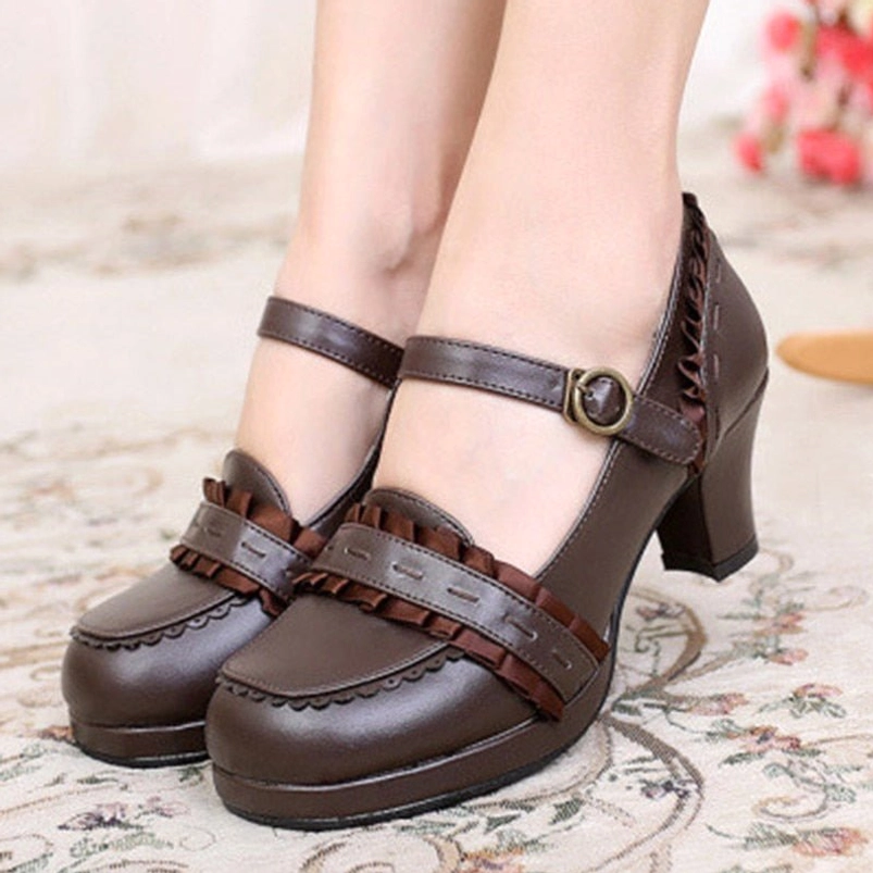 Brown steampunk Mary Jane block heel shoes for women, frontal view showing faux leather material, decorative ruffle vamp trim, antique buckle ankle strap, and sturdy block heel