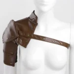 Brown faux leather asymmetrical steampunk shoulder armor with bronze metal rivets and adjustable cross-shoulder strap, displayed on female mannequin from front perspective showing industrial aesthetic and Victorian-inspired design