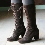 Women's brown suede steampunk lace-up boots with metal eyelets and block heel, front three-quarter view
