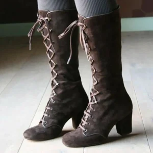 Women's brown suede steampunk lace-up boots with metal eyelets and block heel, front three-quarter view