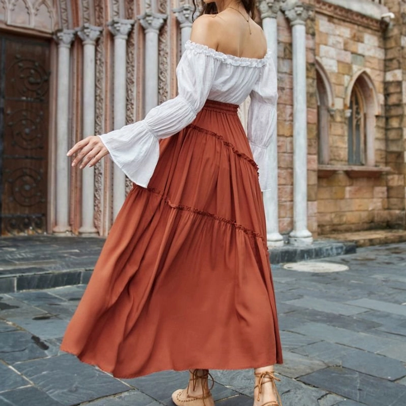 Burnt orange ruffled maxi skirt rear view of model showing full length ankle-sweeping silhouette with cascading tiered ruffles and flowing design