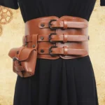Camel brown steampunk corset belt with triple adjustable strap buckles and detachable rivet-reinforced pouch, displayed on mannequin with vintage gear pattern backdrop, front waist view