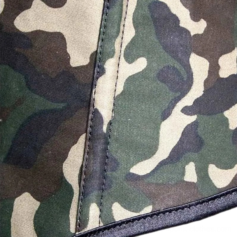 Close-up detail of camouflage canvas fabric and double-stitched seams with black satin binding trim