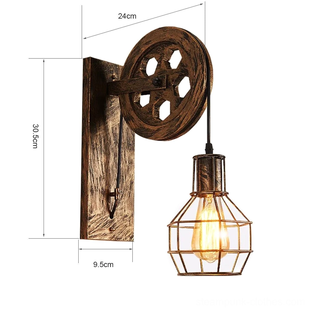 Steampunk wall lamp technical product shot showing aged wood-effect metal bracket, hexagonal pulley design, wire cage lampshade, and dimension measurement markers for sizing reference