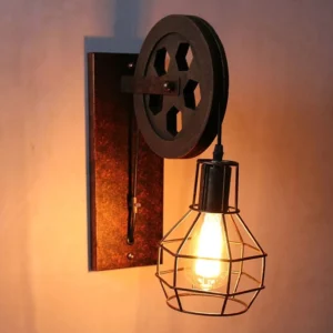 Cardiff steampunk wall lamp with dark bronze pulley-wheel design and geometric wire cage, displayed at left three-quarter angle with warm ambient lighting highlighting rustic industrial character