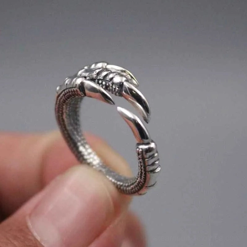 Open claw steampunk ring worn on finger showing detailed metalwork and texture close-up