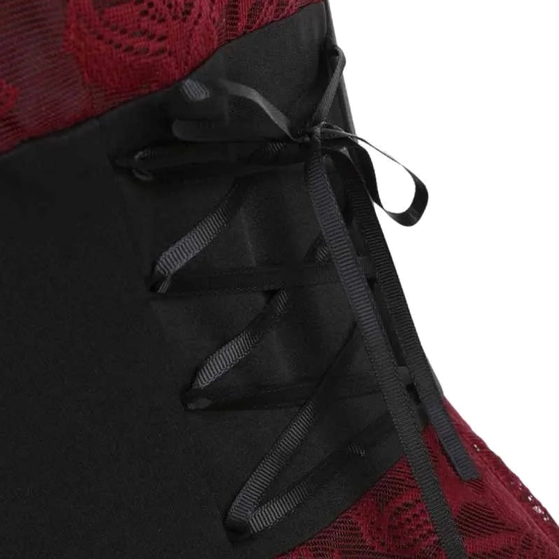 Close-up detail of dress waist corset lacing with black satin ribbon, decorative bow, and floral lace fabric texture
