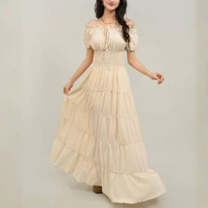 Off-shoulder tiered steampunk maxi dress with smocked waist, puff sleeves, and front bow detail worn by female model in studio