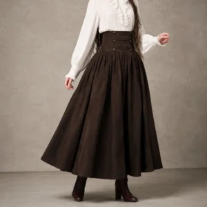 Dark brown high-waisted steampunk maxi skirt with pleated A-line silhouette and decorative buttons, full-body front view on fashion model