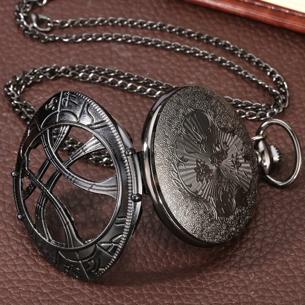Eye-shaped steampunk pocket watch side view showing hinged flip case with embossed decorative patterns and attached metal chain