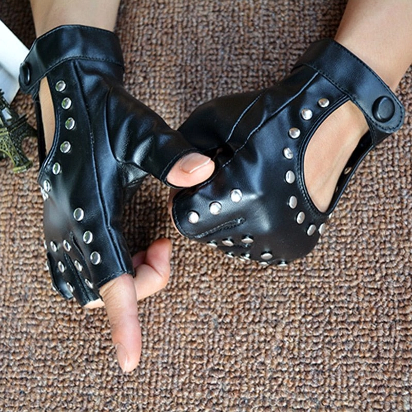 Pair of black studded fingerless gloves hands holding, side close-up view, exposed wrist cutout, silver rivet details, brown background