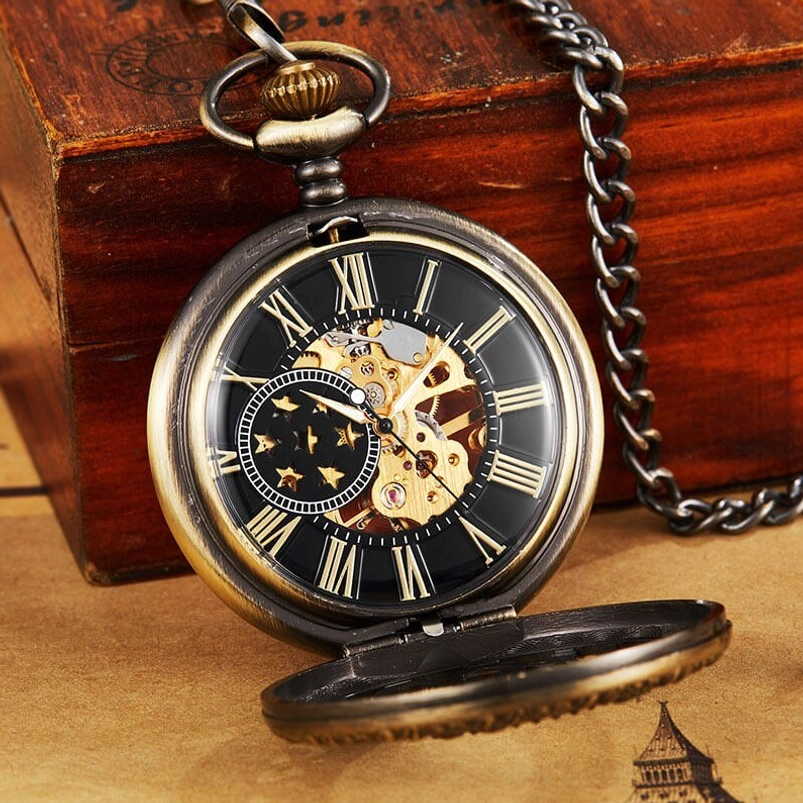 Flip-top steampunk pocket watch featuring bronze case with Roman numeral black dial and exposed skeleton movement, three-quarter view with vintage wooden presentation and newspaper backdrop