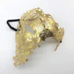 Gold Venetian steampunk half-mask with filigree metal craftsmanship and rhinestone embellishments, featuring ornate baroque scroll designs on white background